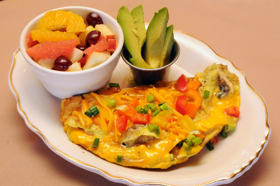 Cheesy veggie omelette with fruit salad - Healthy plate breakfast