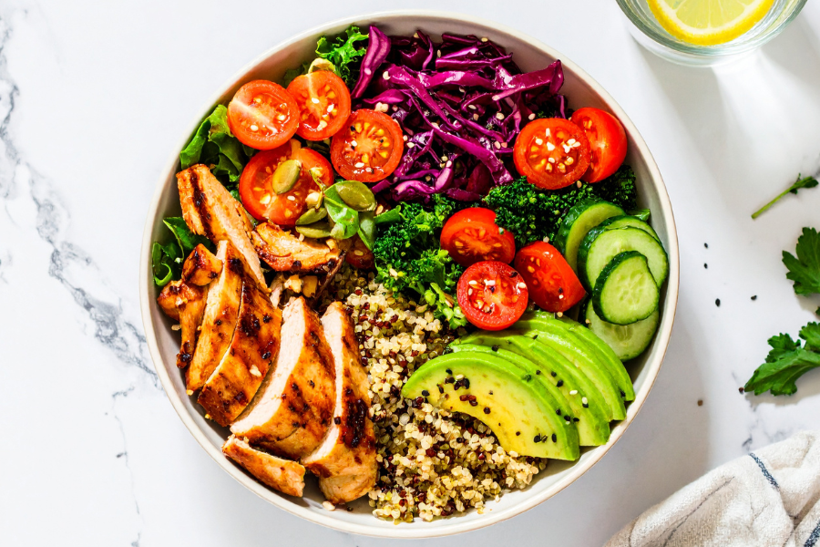 Grilled chicken salad with mixed greens, cherry tomatoes, quinoa, and olive oil dressing. - Healthy Plate Lunch 
